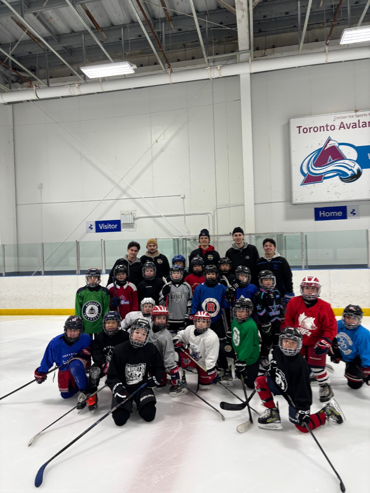 TF Hockey March Break Camp group photo on the ice with coaches and players